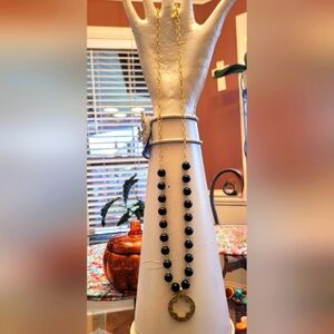 Black beaded necklace with gold dangle.